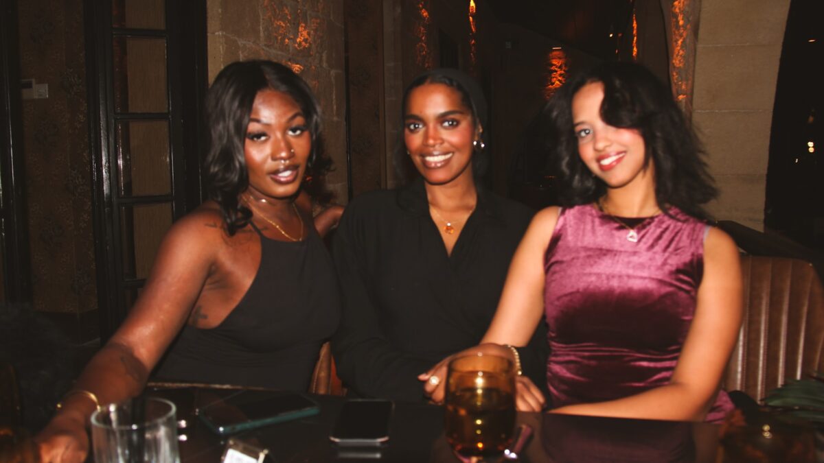 Three women smiling and posing for a photo.